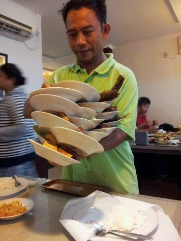 Balancing Plates in a Padang Restaurant